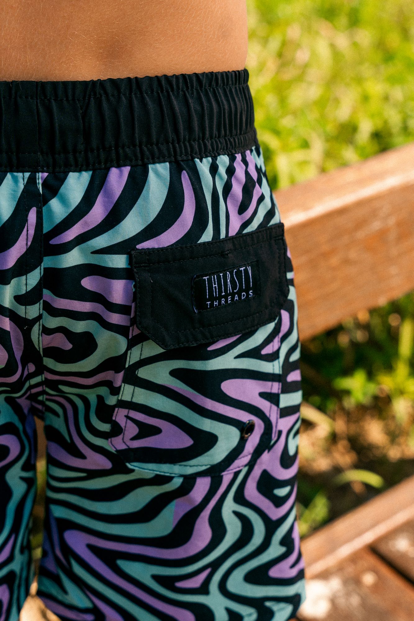 Boy wearing Dreamwave hybrid anti-chafe boardshorts outdoors - Thirsty Threads